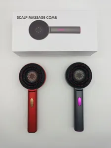 Close up view of electric scalp massage comb showcasing red and grey color design and box.