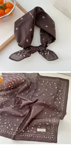 Detailed view of a brown cotton bandana featuring vintage paisley print and cute heart motifs.