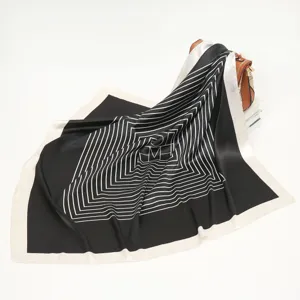 Detailed view of black and white geometric silk scarf, elegant draped square design.