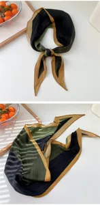Detail view of a chic color-blocked silk scarf featuring black, green, and golden stripes.