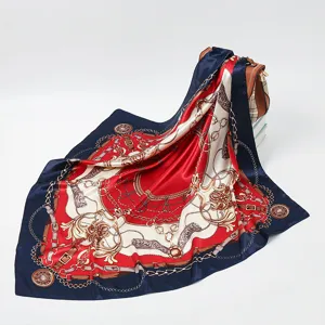 Detail view of a luxurious square silk scarf featuring a chic chain and belt baroque print.