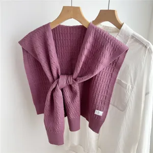 Purple knitted shawl layered over white shirt detail, elegant women winter fashion accessory.