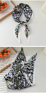 Detail view of the black and white baroque print silk scarf featuring elegant decorative patterns.