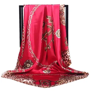 Luxury style red silk square scarf with classic chain and leopard print design for women.