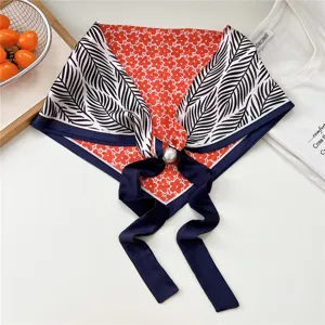 Floral print triangular scarf with pearl magnetic buckle, stylish women neckerchief detail.