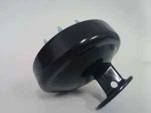 Close-up detail shot of black scalp massage shampoo brush with soft blue silicone bristles.