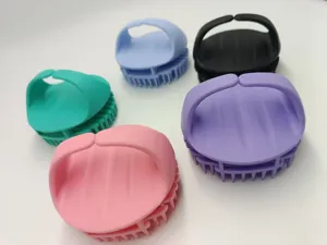 Close-up detail showing multiple colorful silicone scalp massage brushes for hair care.
