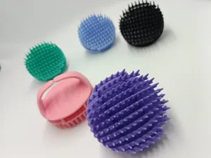 Silicone scalp massage brush detail view showing soft bristles and ergonomic grip handle in colors.