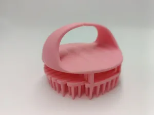 Detailed view of pink silicone scalp massage brush with soft bristles for daily hair wash.
