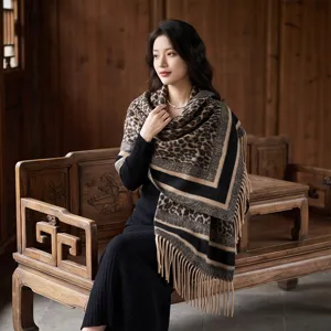 Detailed view of luxury leopard print shawl with thick fringe, soft cashmere-feel fabric.