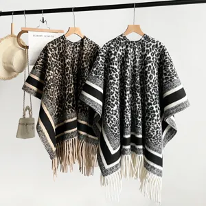 Leopard print knitted shawl poncho with thick fringe hem, stylish winter warm cape detail view.