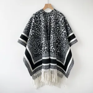 Elegant black and white leopard print poncho with stylish stripe trim and fringe hem for women.