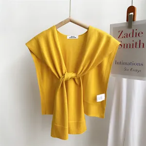 Yellow knit small shawl detail, decorative sweater shoulder wrap, stylish accessory.