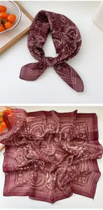 Detailed view of the burgundy paisley silk square scarf showing intricate butterfly patterns.