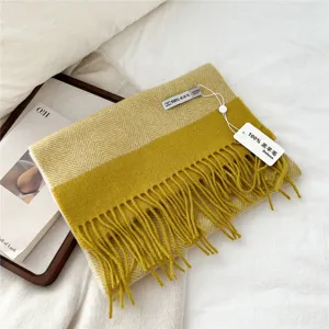 Cozy yellow herringbone lamb wool winter scarf with stylish fringe, warm and soft accessory.