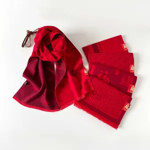 Detailed view of the traditional Chinese New Year red scarf featuring auspicious cloud and Fu patt.