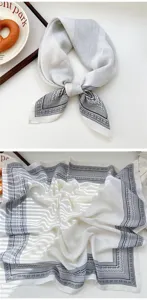 Nahaufnahme Detail des weißen quadratischen Seidentuchs mit klassischem Paisleymuster.
