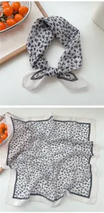 Close-up of black and white floral square scarf, breathable lightweight fabric, detail view.