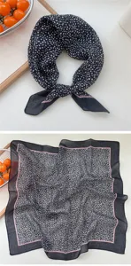 Primo piano dettagliato di un piccolo fazzoletto quadrato in lino nero e bianco con bordo rosa.