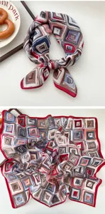 Detailed view of women's geometric print square scarf with elegant red border and soft fabric.