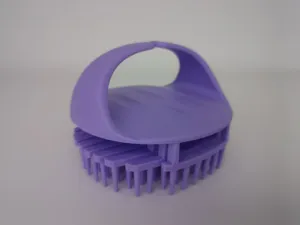 Close-up detail of the purple silicone scalp massage brush, showing the ergonomic handle and bristles.
