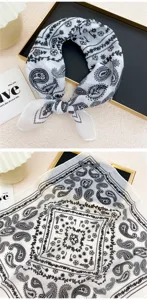 Detailed view of white cotton linen square scarf with classic black paisley and floral print pattern.