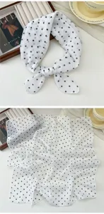 Detailed close-up view of a soft white cotton linen square scarf featuring classic black polka dots.