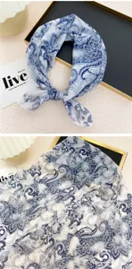 Blue and white paisley pattern detail of cotton linen square scarf neckerchief close up.