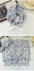 Close-up detail of the breathable cotton linen square scarf with classic black paisley print.