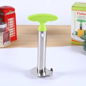 Stainless steel pineapple corer slicer detail, green handle and cutting blade mechanism.