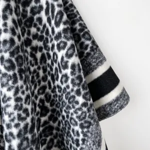 Close-up detail of black white grey leopard print cashmere-like shawl winter cape texture