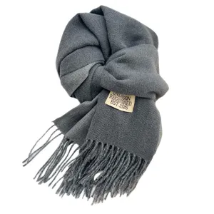 Solid color double-sided imitation cashmere winter warm scarf with tassels and label.