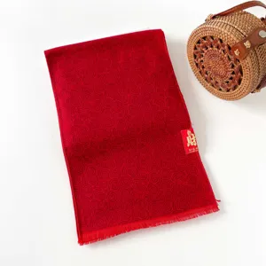 Red winter scarf with traditional pattern, elegant festive shawl for women and men daily wear.