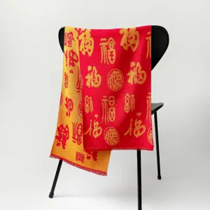 Detailed view of the festive red and gold Chinese New Year scarf with auspicious Fu patterns.