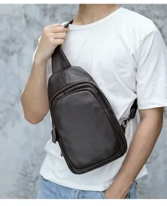 Close-up detail of dark brown leather sling bag, showcasing premium texture and zipper details.