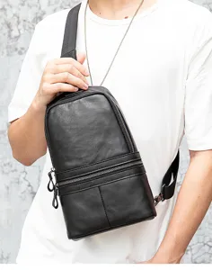 Detailed view of the black genuine leather men chest bag, showing zipper and leather texture.