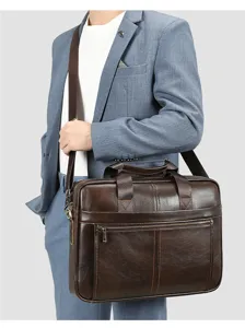 Borsa da lavoro marrone in vera pelle da uomo, indossata a tracolla, dettagli raffinati.