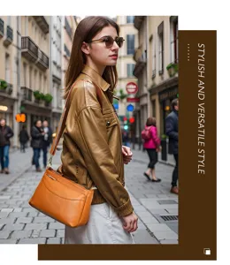 Detailed street view of a stylish genuine leather shoulder bag worn by a model in a city.