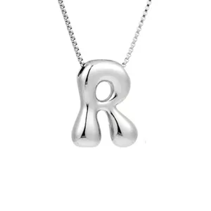 Nahaufnahme des silbernen Buchstaben Anhänger Halskette mit glatter Metallstruktur Glanz.