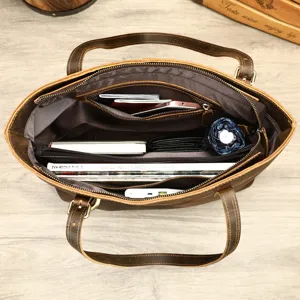 Detailed top view of brown leather briefcase interior showing large capacity and multi pockets.