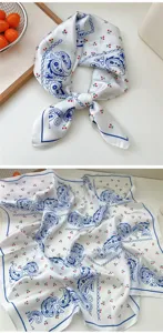 Detailed view of a white silk square scarf with blue paisley and cherry prints.