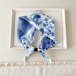 Detailed view of the blue and white paisley cotton linen small square scarf, soft fabric texture.