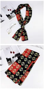 Detailed view of a black red skinny scarf with golden chain print, ideal for neck or bag decor.