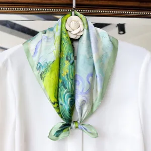 Detailed shot of artistic oil painting style silk small square scarf tied neatly on white blouse.