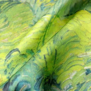 Close-up detail of luxury silk scarf fabric featuring an elegant green oil painting art print.