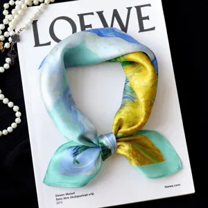 Detail shot of oil painting style silk square scarf, artistic blue and yellow floral pattern.