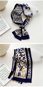Detailed shot of a stylish narrow silk scarf with blue floral and geometric patterns.