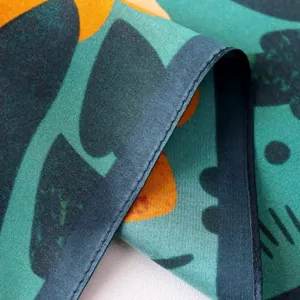 Silk scarf detail close up showing fine stitching and smooth satin fabric texture abstract print