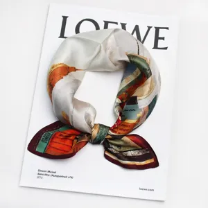 Detailed close-up of the artistic oil painting silk square scarf tied neatly on display.