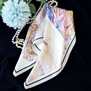 Detail view of a luxury silk scarf featuring an exquisite oil painting art print. Elegant accessory.